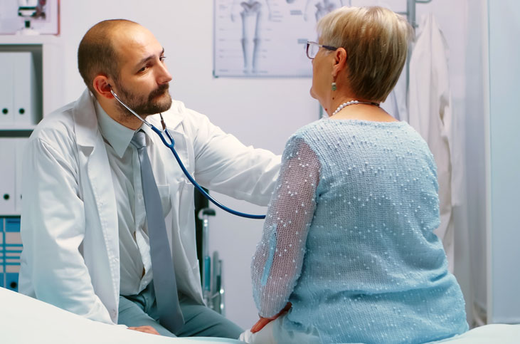 Angular collage featuring two brightly-colored mobile clinics in orange and green