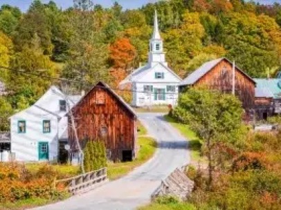 Rural New England village with church, barns and autumn foliage
