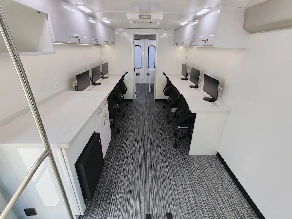 Mobile lab interior with computer workstations and monitors