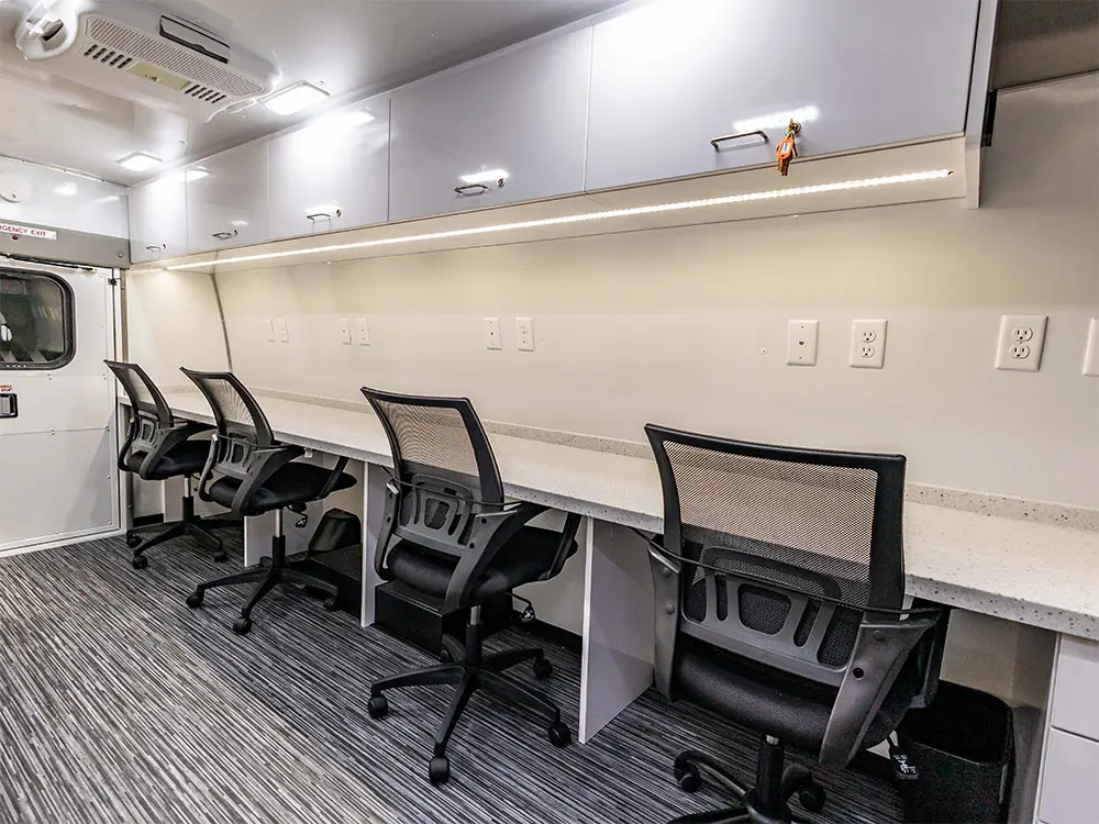 Mobile lab interior with a long work counter and chairs